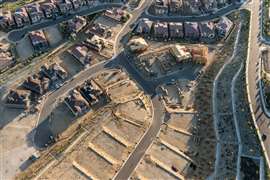 Aerial view of new streets, homes and graded lots near Los Angeles, California