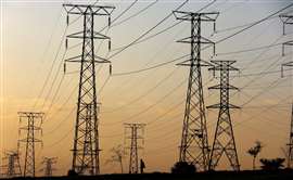 Electricity pylons in silhouette against a sunset in Africa (Image: Reuters)