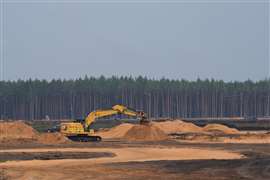 An excavator operates at the construction site of the artillery training area of a German army base in Rudninkai, Lithuania 