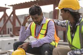 A site worker extending a hand of support to another